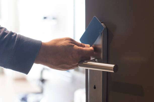 hand touch keycard on hotel door hand touch keycard on hotel door